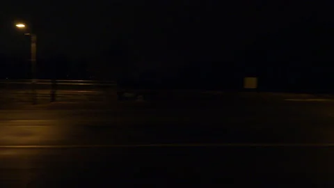 Driving motion shot with side view on dark city streets at night with buildings Vídeos de archivo 149784134