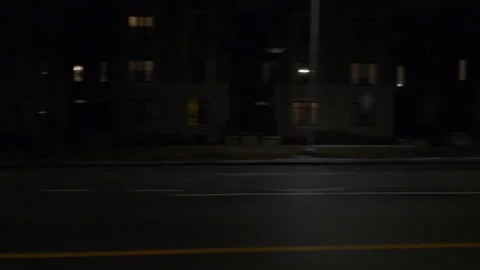 Driving motion shot with side view on dark city streets at night with buildings Vídeos de archivo 149790046