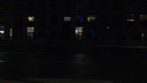Driving motion shot with side view on dark city streets at night with buildings Stock Footage 149791034