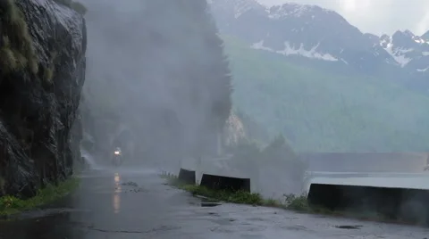 Driving the motorcycle under a waterfall Stock Footage 50980028