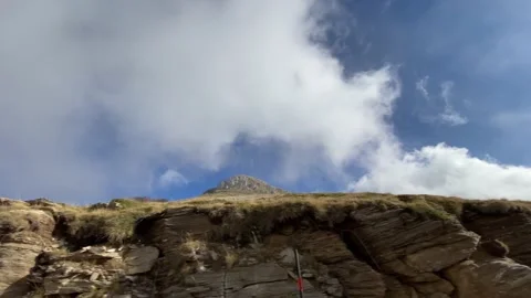 Driving by mountain peak with low clouds. Stock Footage 142742880