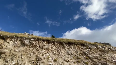 Driving by mountain peak with low clouds. Stock Footage 142743410