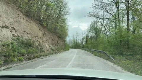 Driving on mountain road through forest POV travel footage Stock-Footage 333708060