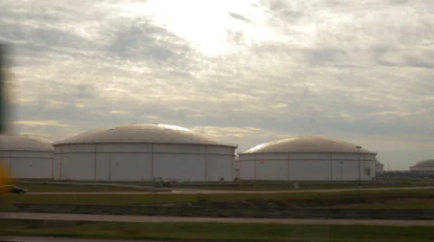 Driving next to oil refinary tanks 4k 스톡 동영상 58685994