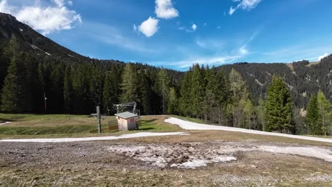 Driving next to Ski Lift  in Spring with only a little bit snow left. Stock Footage 277870164