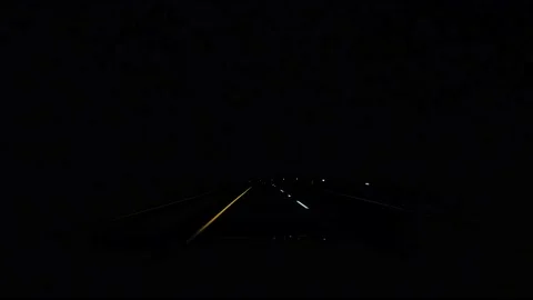 Driving at night at the end of a storm over a mountain Stock Footage 167923541