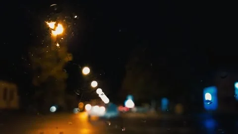Driving at night. Raindrops on the windshield of the car. Asphalt road. Blurred Stock Footage 205036975