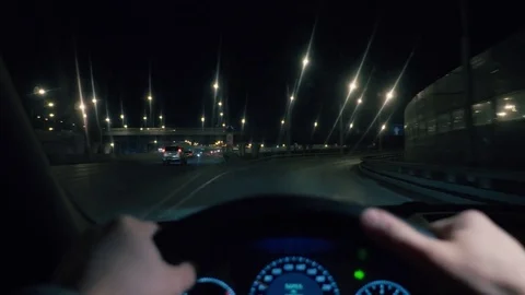 Driving in night scenery, hands on steering wheel. 库存影片 81180994
