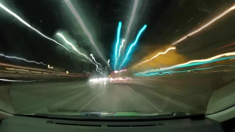 Driving at night through a busy highway with bright lights and fast-moving cars  Stock Footage 335333604