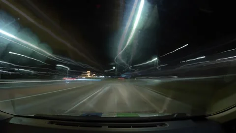 Driving at night through a busy highway with bright lights and fast-moving cars  Stock Footage 335333605