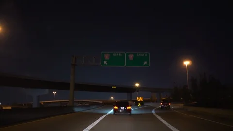 Driving at night through a interchange on a freeway 4k Stock Footage 94129179