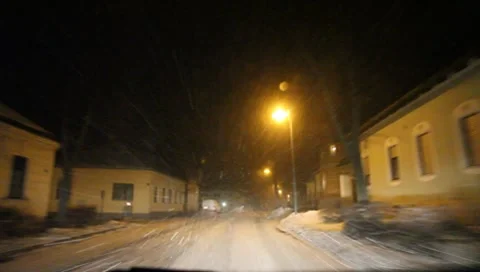 Driving at night through a snow covered village in Lower Austria Vídeos de archivo 8839141