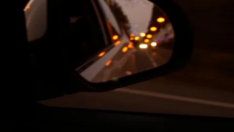 Driving at night. The view from the car on the side rearview mirror while Stock Footage 95423057