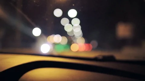 Driving at night. Windshield view of blurred city lights. Handheld shot Stockbeeldmateriaal 79091590