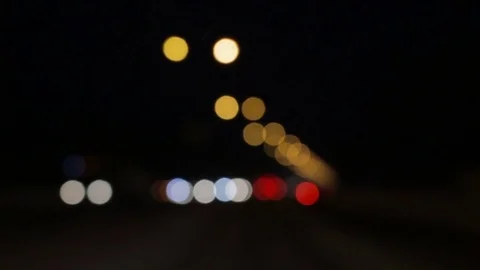 Driving at night. Windshield view of defocused car lights in the darkness Stock Footage 71006764
