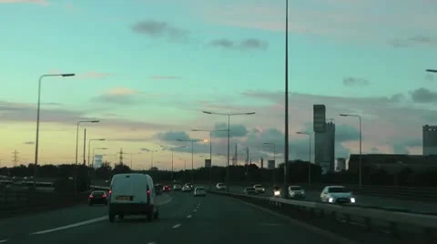Driving north over Tees Flyover at sunset, passing towers of chemical industry Stock-Footage 12590966