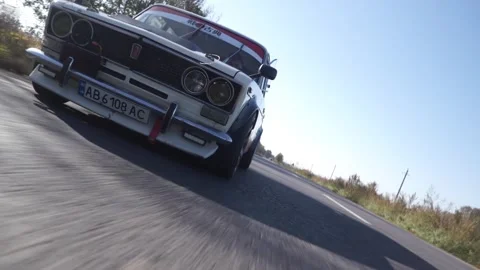 Driving An Old Car On The Forest Road. An old racing car is extreme driving Stock Footage 247197307