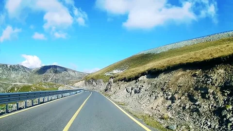 Driving on an open road in the mountains with views of mountains Stock Footage 71489508