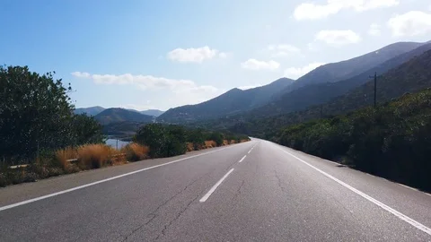 Driving or camera view of a low-flying drone. Mountain road on the island of  Stock Footage 121529553