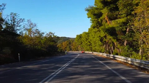 Driving or camera view of a low-flying drone. Mountain road on the island of  Stock Footage 122572348
