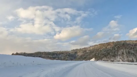 Driving over bridge through snowy winter forest landscape Stock Footage 265637980