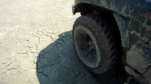 Driving over cracked soil, wheel view Stock Footage 14808264