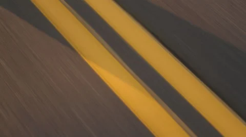 Driving Over Double Yellow Lines on Road at Sunset Stock Footage 56777211