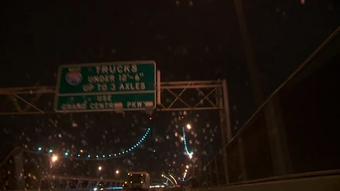 Driving over Manhattan Bridge during thunder and lightning storm, night. Video stock 107992917