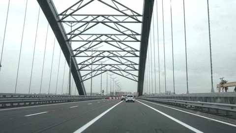 Driving over a modern bridge. POV car dashcam footage on highway.. Stock Footage 312262440