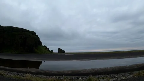 Driving past Arnardrangur basalt stack and black sand plains, Iceland Stock-Footage 334680539