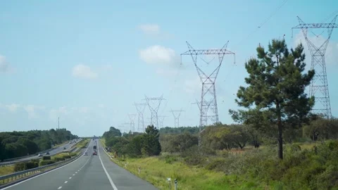 Driving past big power lines next to highway Stock Footage 273673673