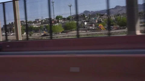 Driving Past Border Fence Overlooking Juarez Mexico from El Paso Texas Stock Footage