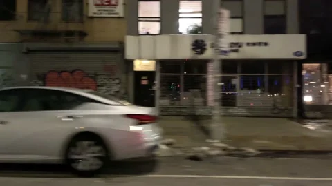 Driving past closed shops stores gates down graffiti East Village New York NYC Stock Footage 148504744