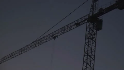 Driving past a construction crane in the evening Stock Footage 206388942