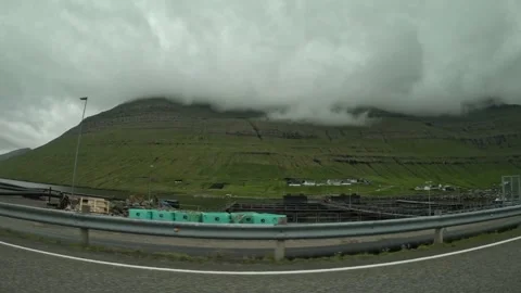 Driving past a fish farm facility and harbor in Klaksvik, Faroe Islands Stock Footage 340082443