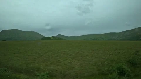 Driving past flat green plains and peat bog in Andoya Norway Stock-Footage 343131322