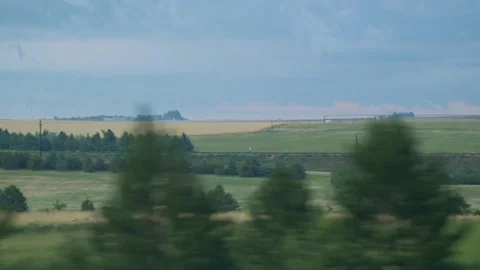 Driving past green open fields Stock Footage 79851607