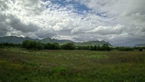 Driving past green wildflower fields and red barn in Andoya Norway Vidéo 343379883