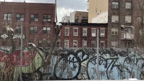 Driving past gritty graffiti wall fence Williamsburg Brooklyn New York City NYC 스톡 동영상 148005192