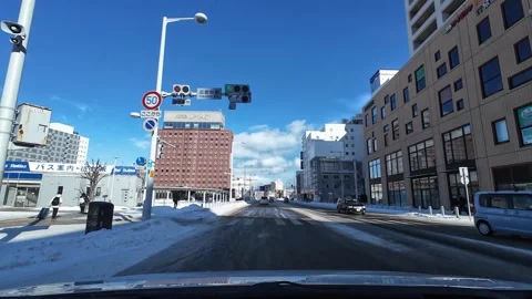 Driving past intersection with pedestrians waiting in Hakodate winter city Video stock 333069382