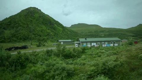 Driving past local shooting range building and green mountain in Andoya Norway Vídeos de archivo 343131314