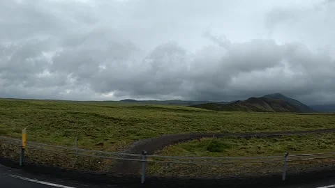 Driving past mossy lava fields and mountain intersection in Iceland Stock Footage 334999607