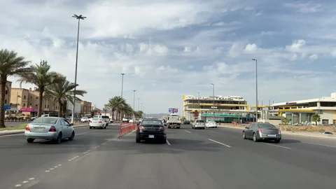Driving Past Palm Trees and Modern Buildings in Medina Vídeo Stock 333935007