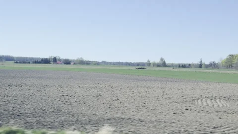 Driving past plowed fields and green panning Vídeos de archivo 333652729