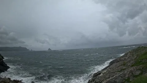 Driving past rocky coastal cliffs with distant Bleiksoya island in Norway Stock-Footage 343131108