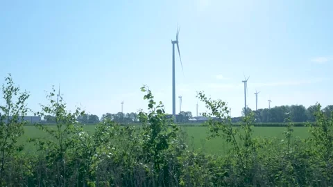 Driving past a wind farm generating renewable energy Видео 336902966