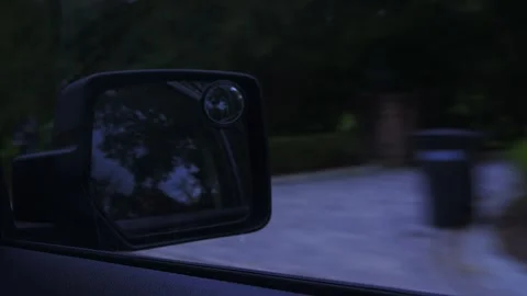 Driving perspective from inside a car, side mirror reflecting rural... Stock Footage 319881295
