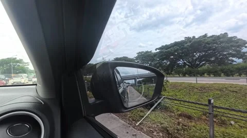 Driving Perspective Shot Featuring a Side Mirror Reflection and Open Scenery Stock Footage 300819862