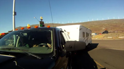 Driving - a pickup and RV trailer turn on Hwy 97 from service area, Oregon, 4 Stock Footage 167181776