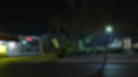 Driving plate night soft focus  store fronts Stockbeeldmateriaal 300135995